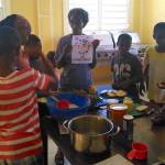 Contributed Photo | Rosedanie Cadet and children at an orphanage in Mirebalais, Haiti make upside-down pineapple cake.