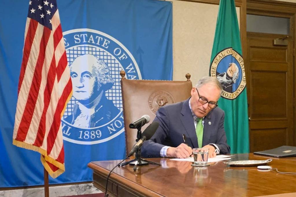 Gov. Jay Inslee signs legislation to help with the states response to the COVID-19 outbreak, including $200 million for emergency response. The bill signings was held with limited attendance while the public watched live video and media asked questions via teleconference. (Office of the Governor Photo)