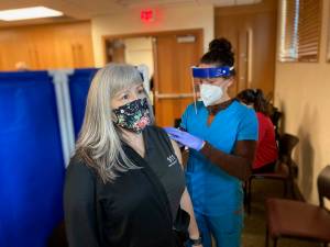 A San Juan County nurse gives the first vaccine in the county on Dec. 30. Per state and federal guidelines, initial vaccine distribution is limited to healthcare professionals, emergency responders, and long-term care facility staff and residents. (Contributed photo)