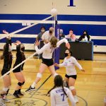 Corey Wiscomb/contributed photo
Tayla Malo (21) and Seraphine Knapp (7) stay ready as Lindsey Simpson (11) swings for the kill.