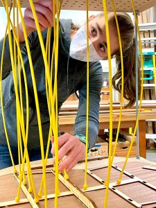 Contributed photo
Bethany Carter utilizing the specialized Go-Bar Deck to do some advanced gluing and bracing on the back of her guitar. There are actually no flat surfaces on the guitar (everything is curved), so the glue and fastening process is very unique and inspiring.