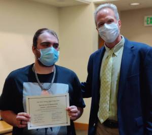 Contributed photo
Jordan Lynn-Jefferson receiving a Certificate of Graduation from San Juan Drug Court with Brad Fincher, Drug Court Case Manager.