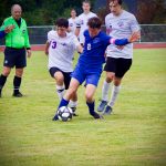 Corey Wiscomb photo
Tommy Anderson-Cleveland maintains control of the ball and position against FH players.