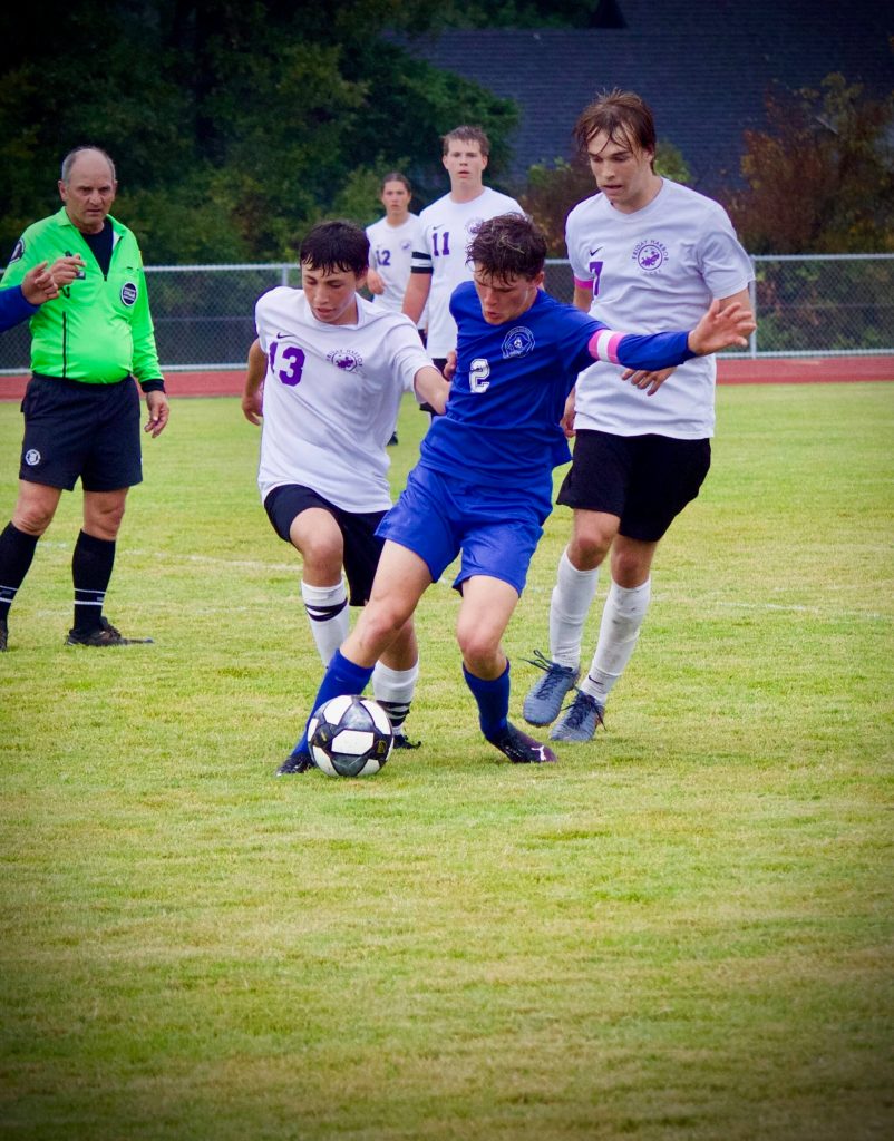 Corey Wiscomb photo
Tommy Anderson-Cleveland maintains control of the ball and position against FH players.