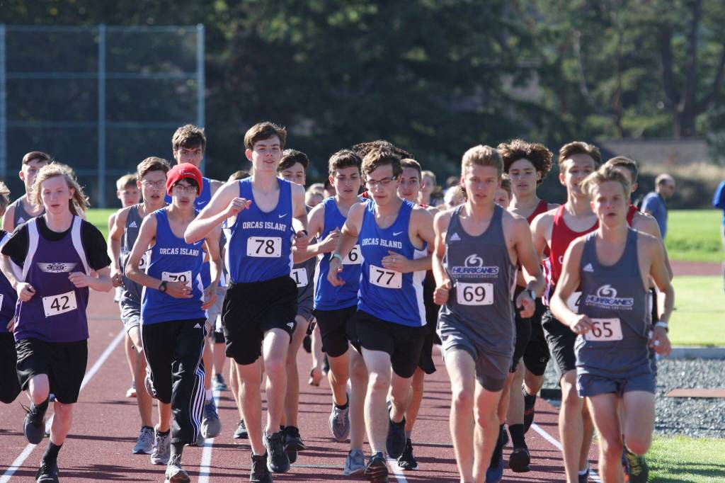 Alyson Stephens photo The OHS Cross Country team of Theo Vaccarella (#79 red hat); Hunter Knapp (in blue behind); Will Stephens (78); Justin Krisch-Derr (76); and Ryan Krisch Derr (77) begin the Orcas event at the new track at Orcas High School.