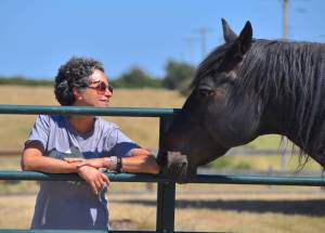 Kelley Balcomb-Bartok  Staff photo
Founder Julie Duke enjoys the company of horses, spending some quality time with Hans.