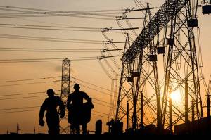 Contributed photo by OPALCO
Silhouette of engineer looking at blueprints in a building site over Blurred substation