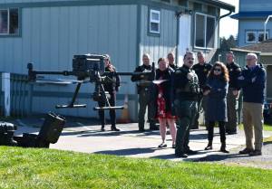 Kelley Balcomb-Bartok / Staff photo
San Juan County Sheriff Deputy and FAA-certified drone pilot Isaac Norton prepares to land the departments new drone as members of the San Juan County Sheriffs office, County Council and county staff look on. Watching the demonstration are left to right: Chief Civil Deputy Kim Ott, Deputy Ron Krebs, Council member Christine Minney, Sergeant Zac Reimer, Pilot/Deputy Isaac Norton, Chief Deputy David Alexander, Council member Jane Fuller, Undersheriff Michael Hairston, and County Manager Mike Thomas.