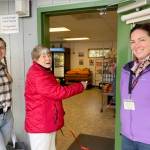 Rick Rhodes photo.
Carolyn Carroll cuts the ribbon and becomes the first customer to experience full self-service at the Orcas Island Food Bank with (left) Operations Manager Alison OToole and Executive Director Amanda Sparks (right).