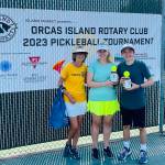 Tournament director Linda Hamilton with Group B Mixed Doubles second-place winners Monica Connell and Ethan Brazil.