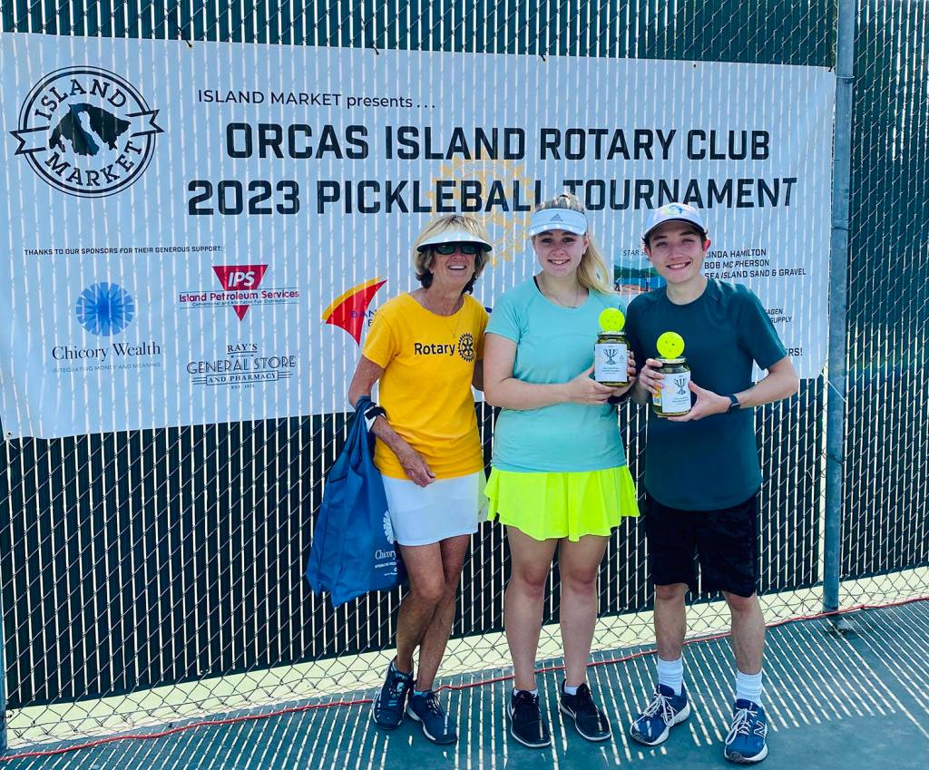 Tournament director Linda Hamilton with Group B Mixed Doubles second-place winners Monica Connell and Ethan Brazil.