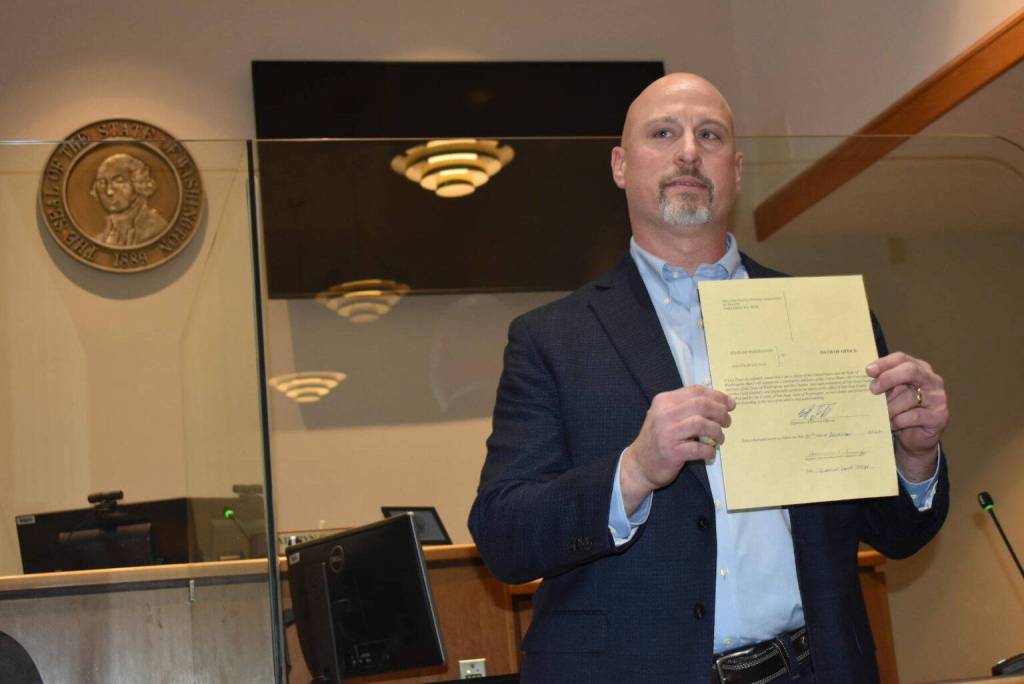 Kelley Balcomb-Bartok Staff photo. Newly Elected Sheriff Eric Peter displays his official election paperwork during a ceremony Dec. 30, 2022 at the Superior Court courtroom.