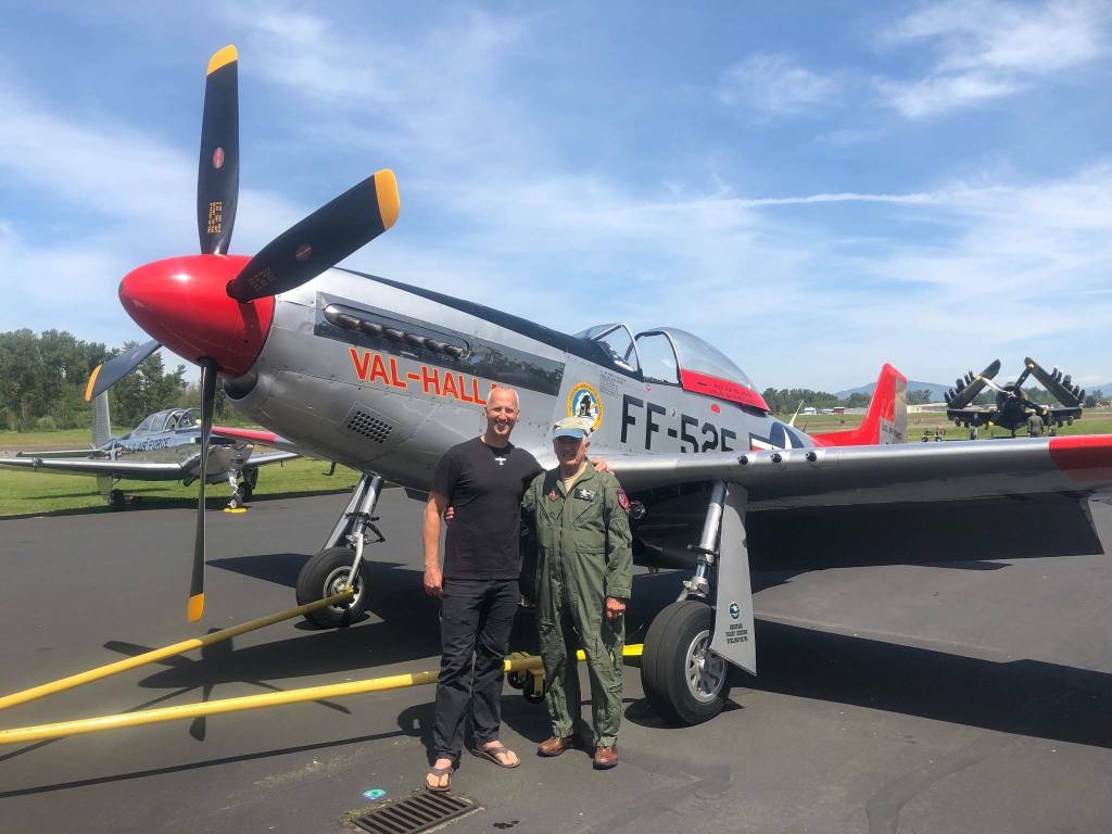 Bill Anders (right) with SeaDoc Society Chief Scientist Joe Gaydos in 2019 after Bill and his wife Valerie surprised the nonprofit with a $50,000 donation to support Salish Sea research. The two are pictured with Bills vintage P-51 Mustang aircraft.