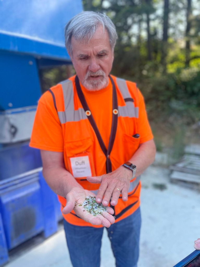 Colleen Smith Summers photo.
ORS board treasurer Jim Duff Duffield showing some of the crushed glass, which can be used in landscapes and gardens.