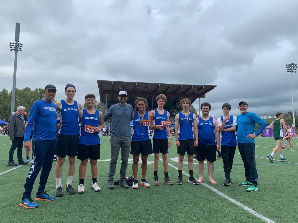 The track team. L-R, head coach Michael Kulper, Robin Limbach, Kenneth Farani, Assistant Coach Matt Tong, Tom Malo, Drew Nunez, Fin Ontjes, Max Peterson, Hugh Kirk and Assistant Coach Bill Kramer.