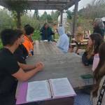 <em>Students and teacher Anna Vedder learn about composting and the impact it can have. </em>