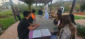 <em>Students and teacher Anna Vedder learn about composting and the impact it can have. </em>