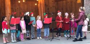 Mary Wachter leads the Kids’ Chorus at the tree lighting on the Eastsound Village Green, Dec. 6.
