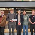 The Orcas chess team, L-R: Thurmond Russell, Max Vollmer, champion Lamai Hons, Orion Johns, and Colter Bond.