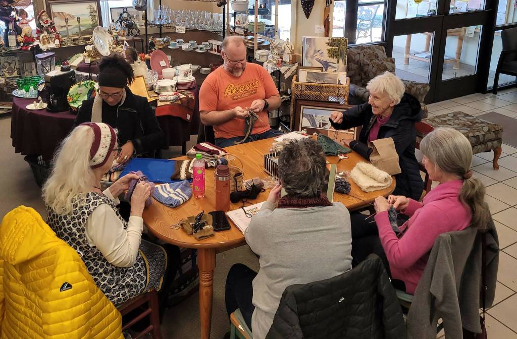 A group engages in needlework.