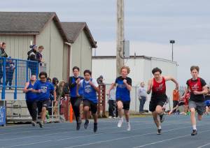 OIHS athletes compete in the 100-meter race, in the back: L-R, Max Peterson, Hugh Kirk and Owen Carlson.