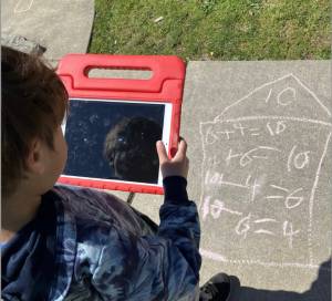 Aiden Parkerson posting a photo of his outdoor math practice and describing it to his parents.