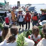 Darrell Kirk photo.
The canoes arriving in Olga, being greeted by Salmonberry students.