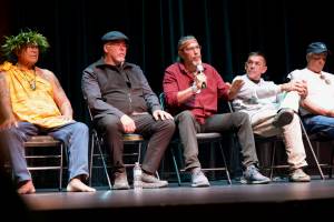 Darrell Kirk photo.
Mike Jones (Haida), tribal president of Kasaan Village, speaks to the gathering at Orcas Center. Left to right: Kimokeo Kapahulehua (Maui); artist Christian White (Haida); Mike Jones (Haida); Jay Julius (Lummi) president; and Dana Wilson (Lummi).