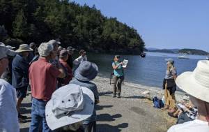 A coastal scientist guides participants through an exploration of shoreline ecosystems.