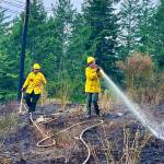 Ben Luna photo.
Firefighters work to put out the wildland fire.