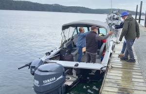 Darrell Kirk photo.
Captain Tom Bridge and passenger Teresa Catford welcome additional passengers onto the water taxi.