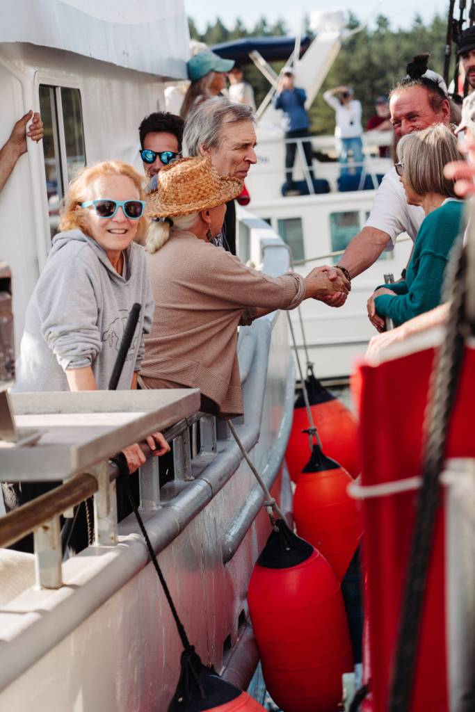 Orcas Video photo.
Orcas Islanders (far left) shaking hands with Canadians during the flotilla.