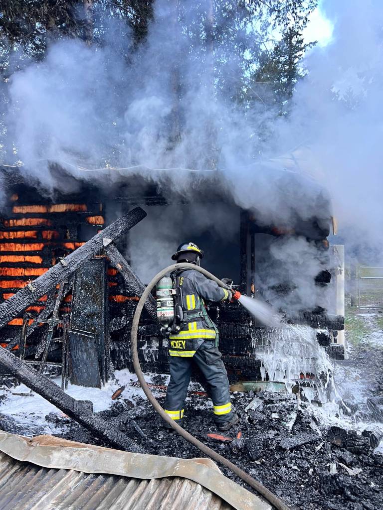 Firefighter Ted McKey hard at work at the structure fire on Feb. 23.