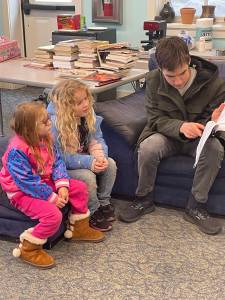 Contributed photo.
An older student reads to two younger students for Reading Month at Orcas Christian School.