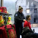 LT Amie Stevens (paramedic, firefighter, instructor) is braiding the hair of Bee Schermerhorn.