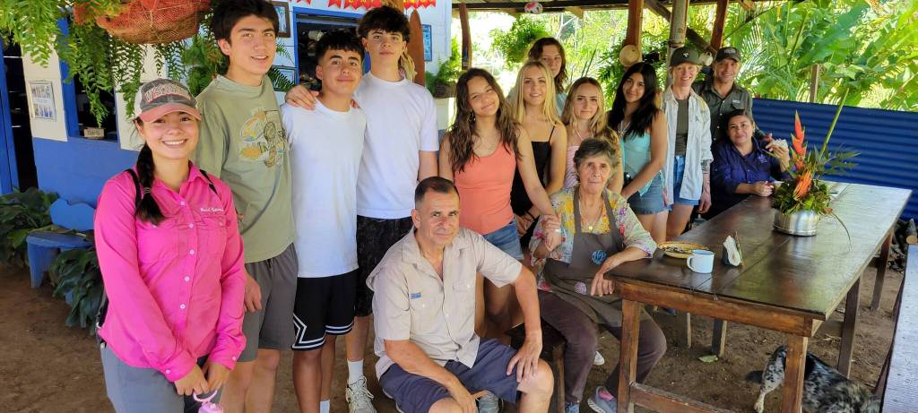 Contributed photo.
The OIHS Culture Travel Clubs visit to a traditional farm and home in Costa Rica. Left to right: Farm Host daughter, Sam Vaccarella, Amaru Shanks Morales, Hayes Richardson, transportation driver (sitting down), Leela Griesemer, Wren Ontjes, Olive McKenzie, Joselyn Carpenter, farm abuela (sitting down), Lucy Rios, Sommer McKenzie, farm host dad and mom.